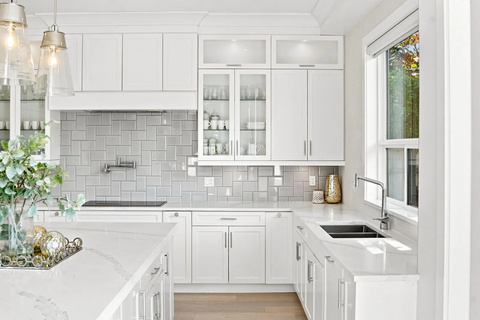 Bright white kitchen with quartz counters photographed for a real estate listing